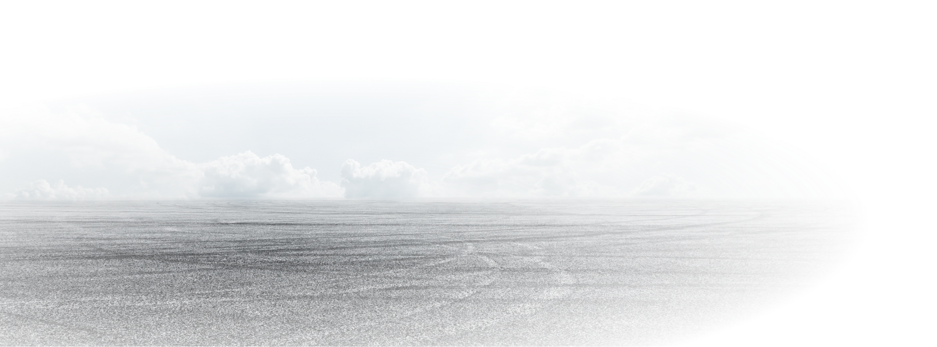 Grey, hazy, monochrome landscape with clouds and flat expanse of ground. | Golden Gear Automotive