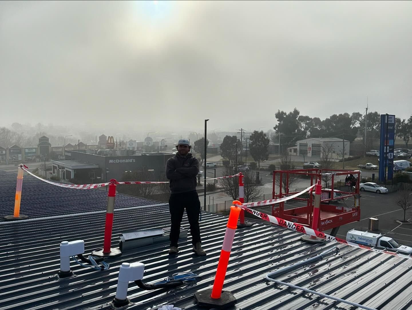Person Standing on A Corrugated Metal Roof — Canobolas Air in Orange, NSW