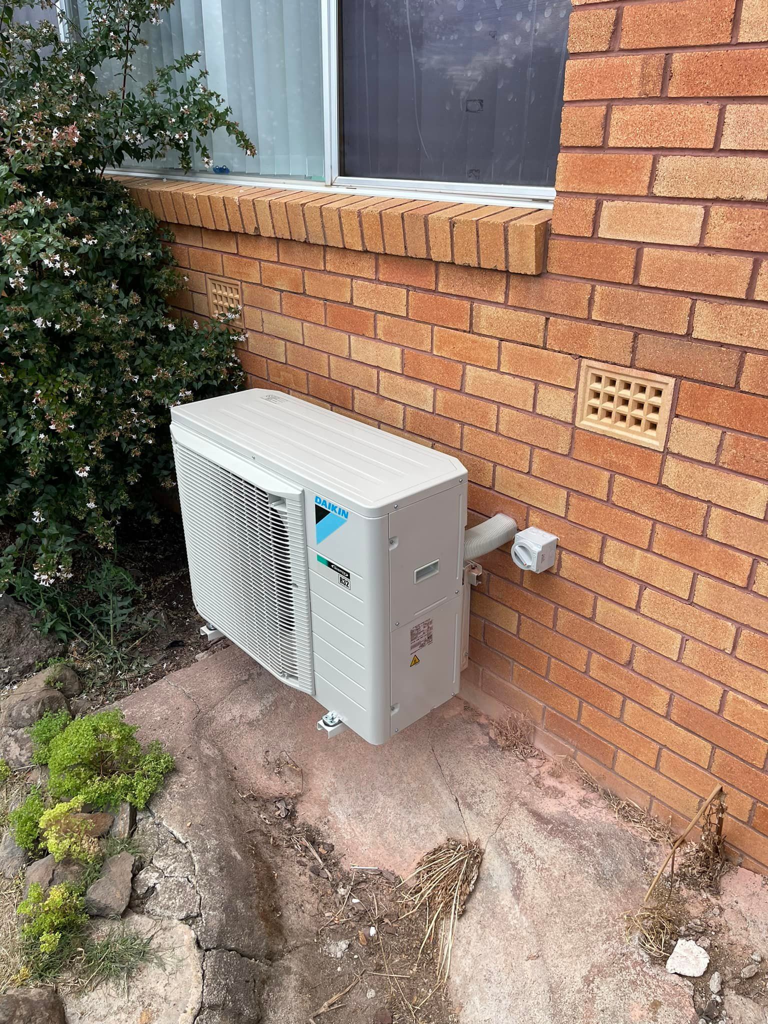 Air Conditioning Unit Mounted on A Brick Wall — Canobolas Air in Oberon, NSW