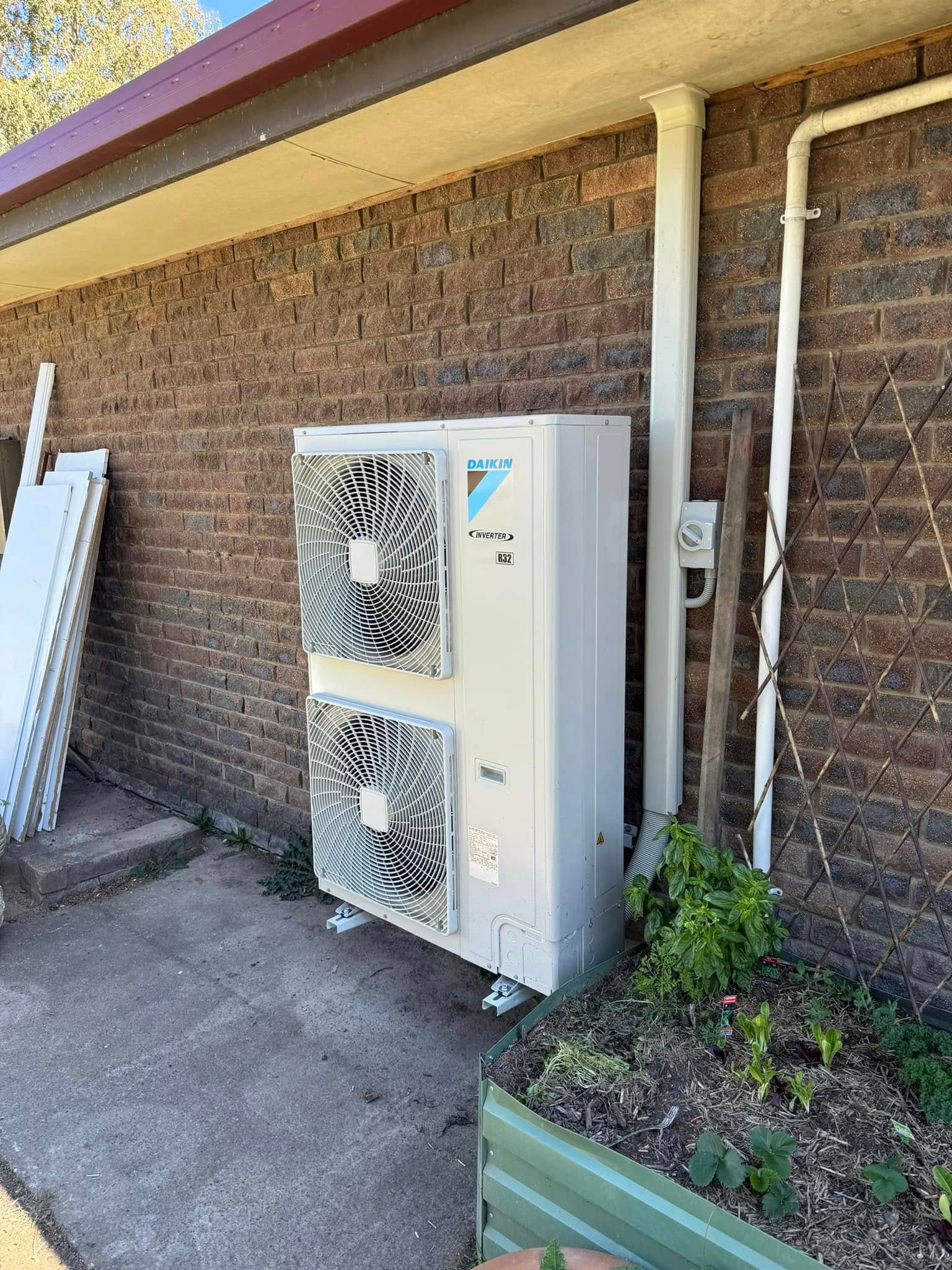 Air Conditioner Unit Mounted on A Brick Wall — Canobolas Air in Bathurst, NSW