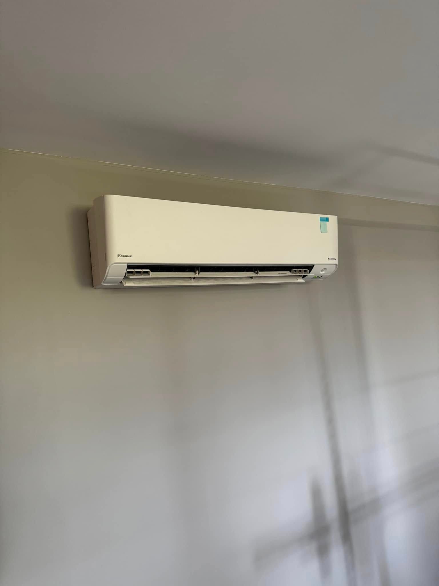 White Air Conditioning Unit Mounted on A Gray Wall — Canobolas Air in Bathurst, NSW