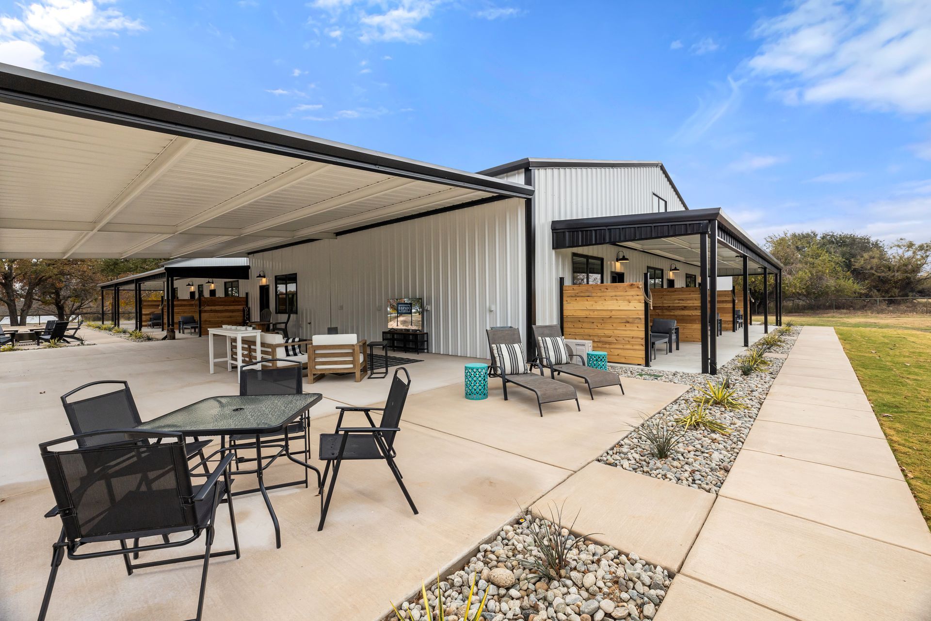 A patio with a table and chairs under a canopy.