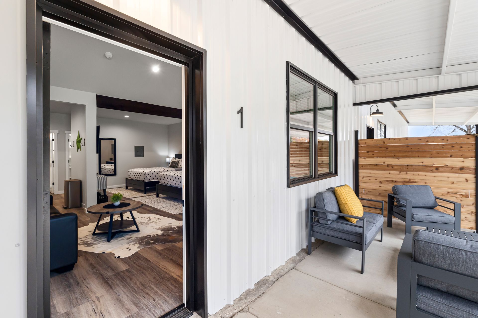 A living room with a couch , chairs and a table.