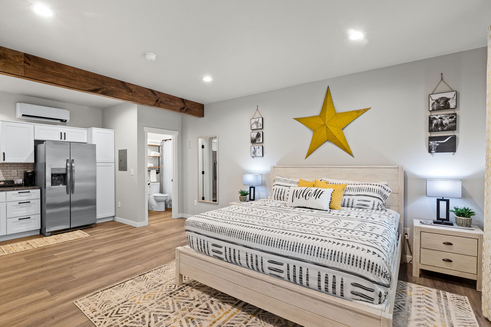 A bedroom with a king size bed and a star on the wall.
