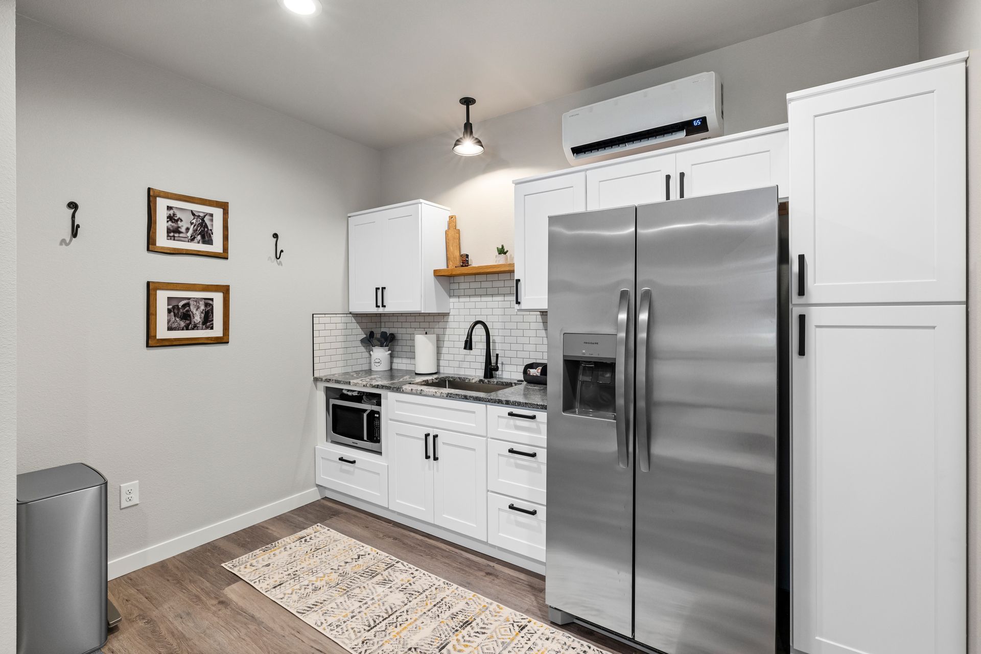 A kitchen with stainless steel appliances and white cabinets.