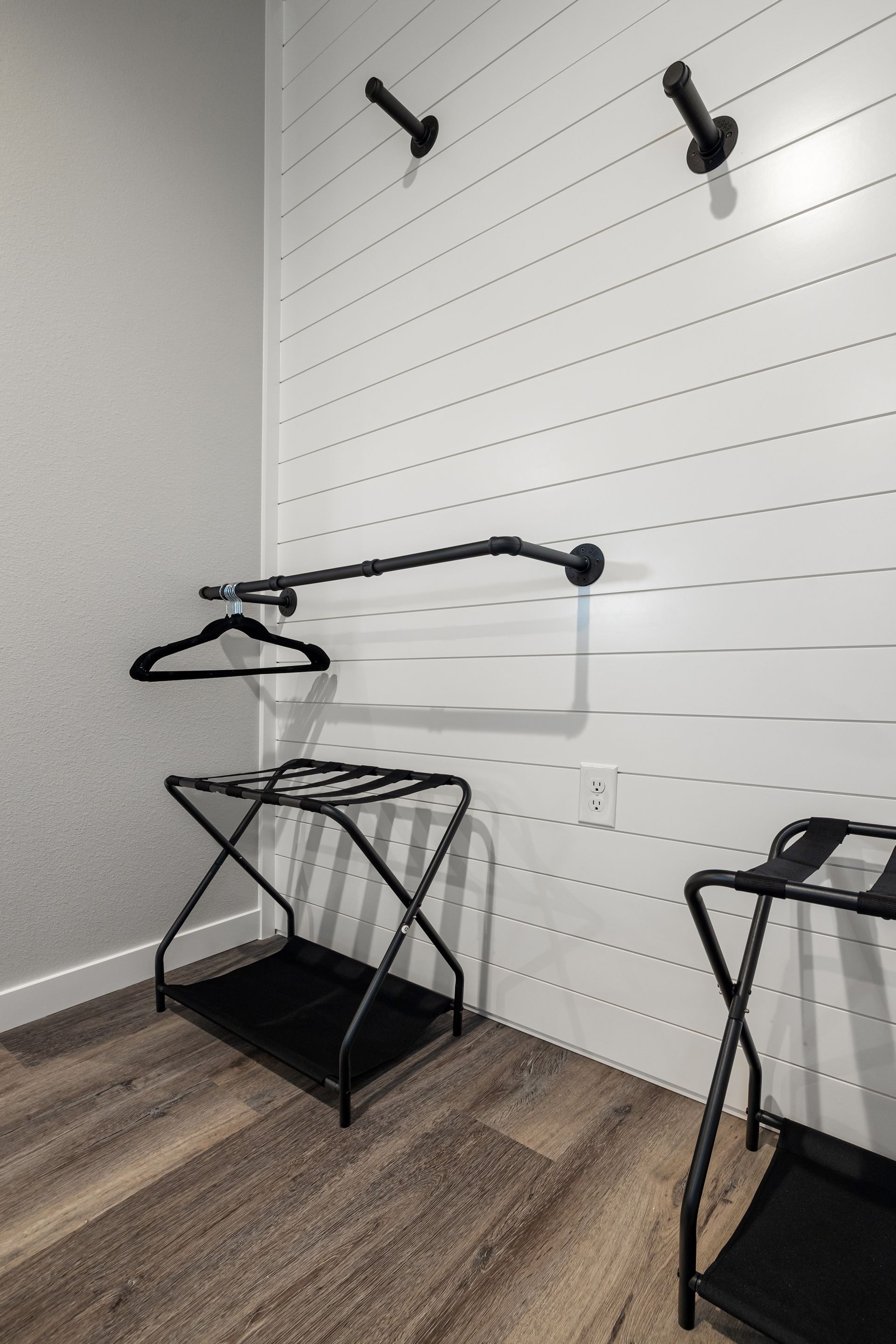 There are two luggage racks in the closet.