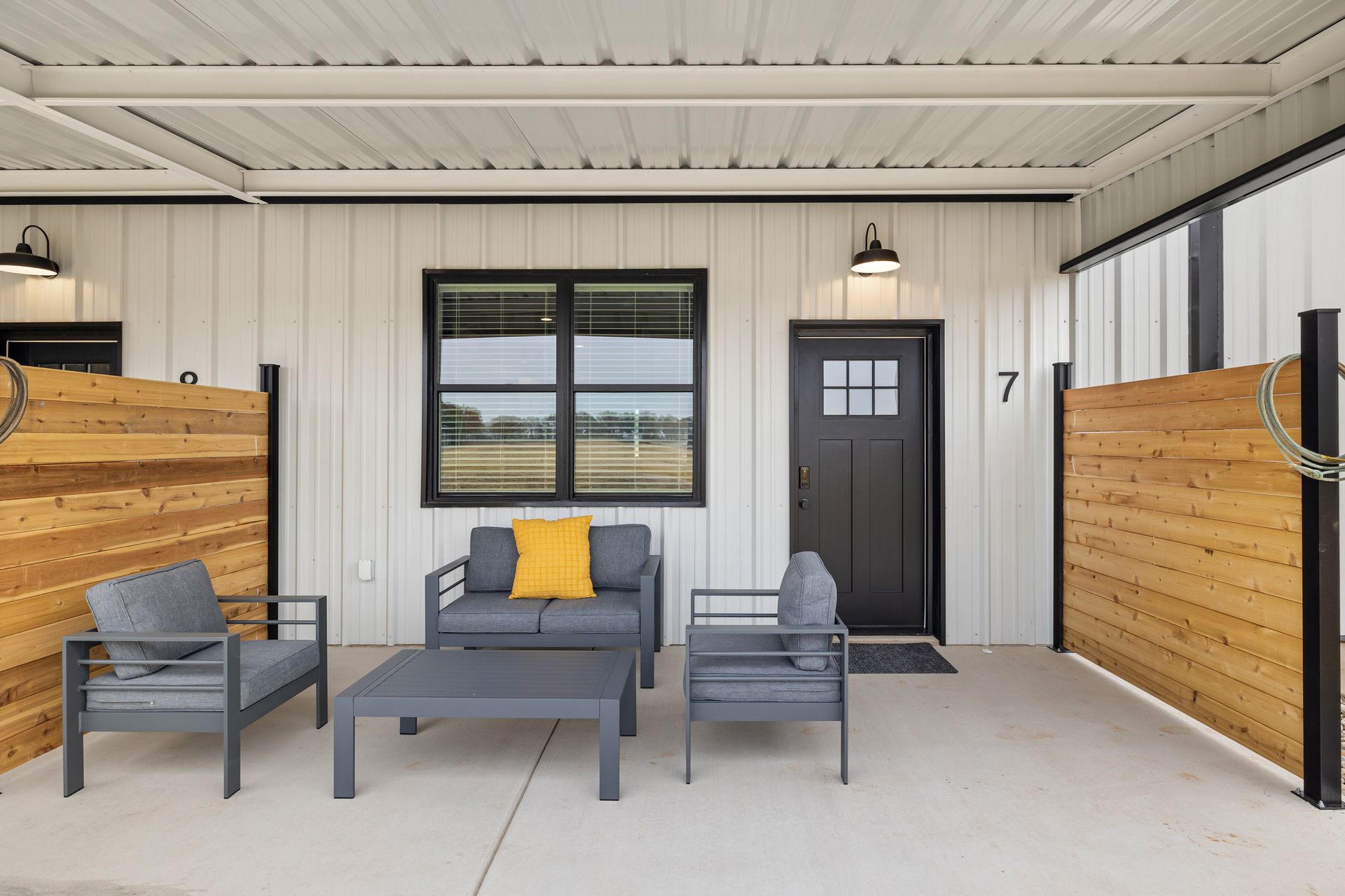 A living room with a couch , chairs , and a table.