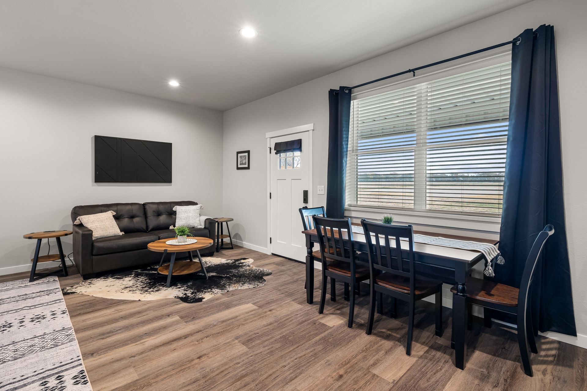 A living room with a couch , table and chairs.