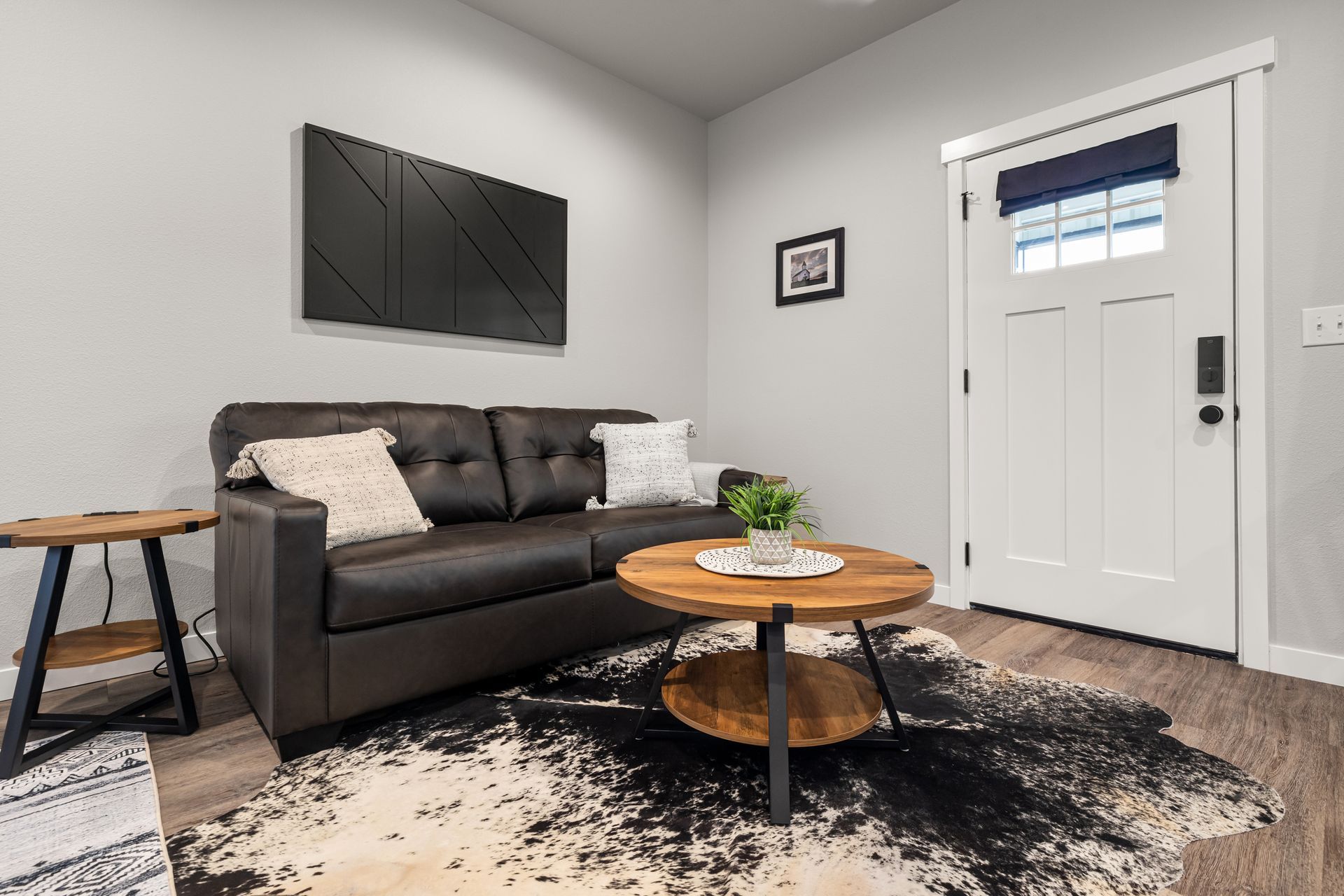 A living room with a couch , coffee table , and rug.