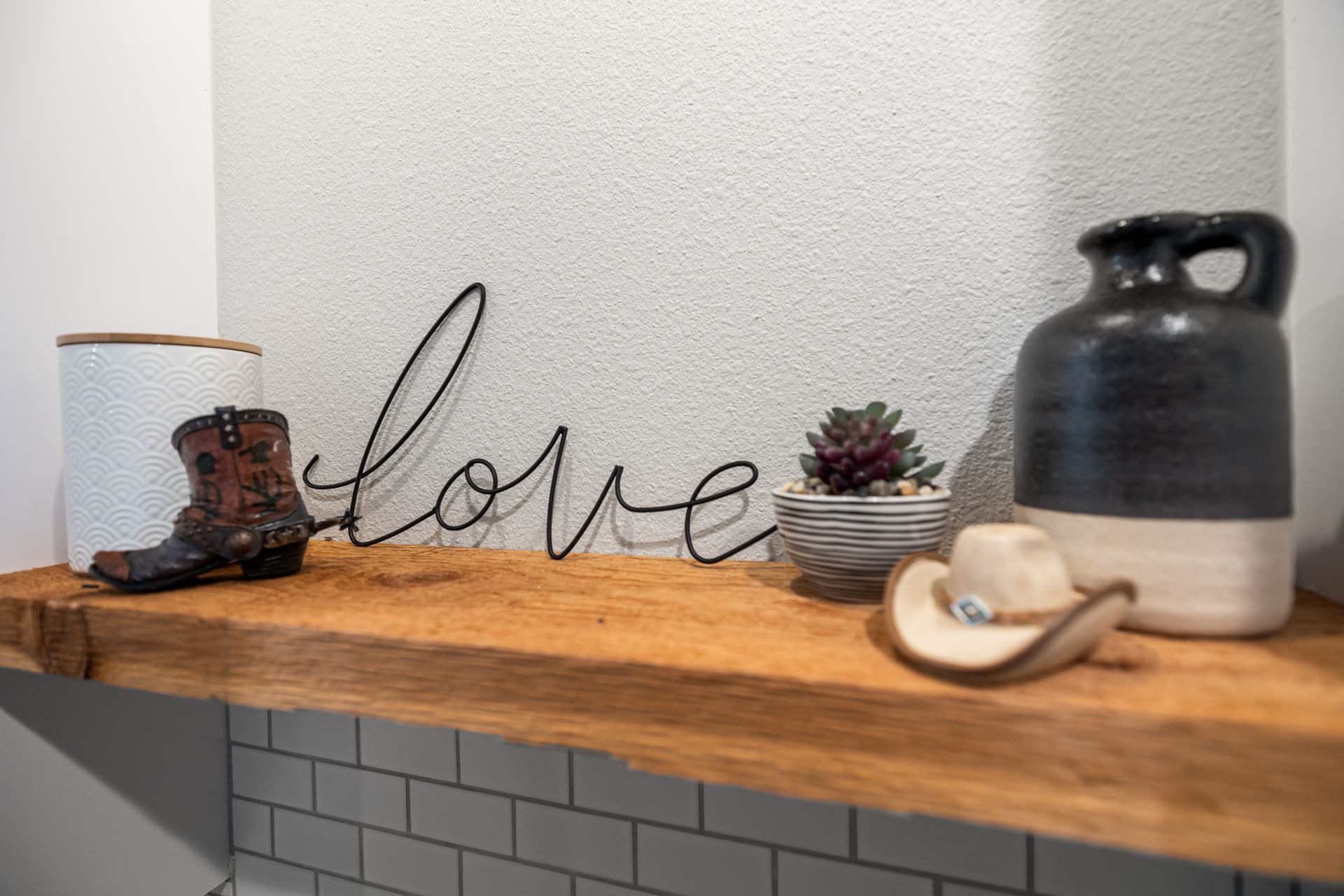 A wooden shelf with a sign that says `` love '' on it.