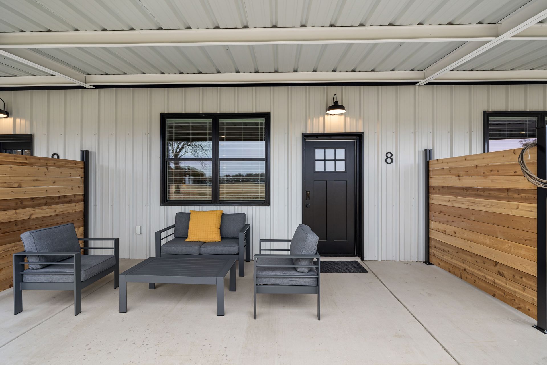 A living room with a couch , chairs , and a table.