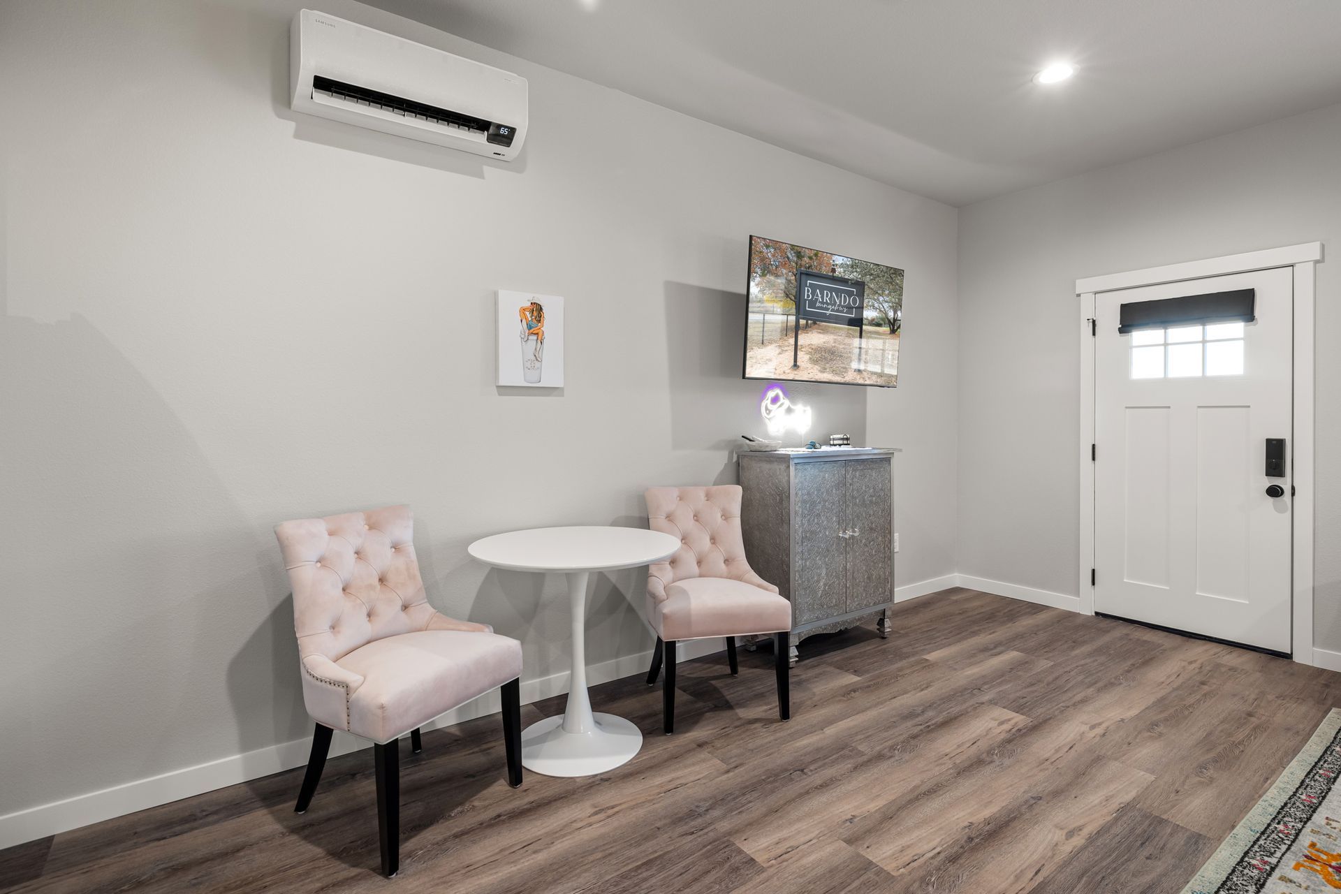 A living room with two chairs and a table.