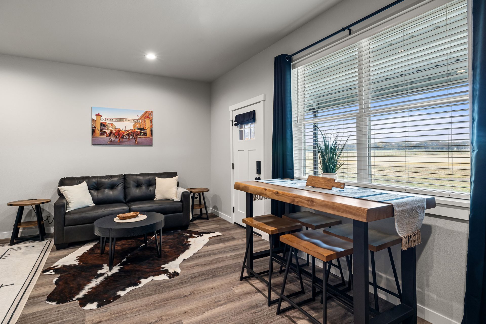 A living room with a couch , table and chairs.
