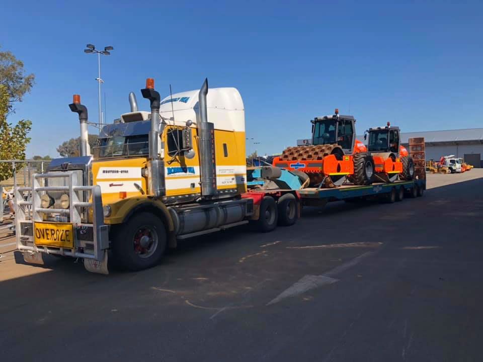 Prime mover towing a low loader with rollers