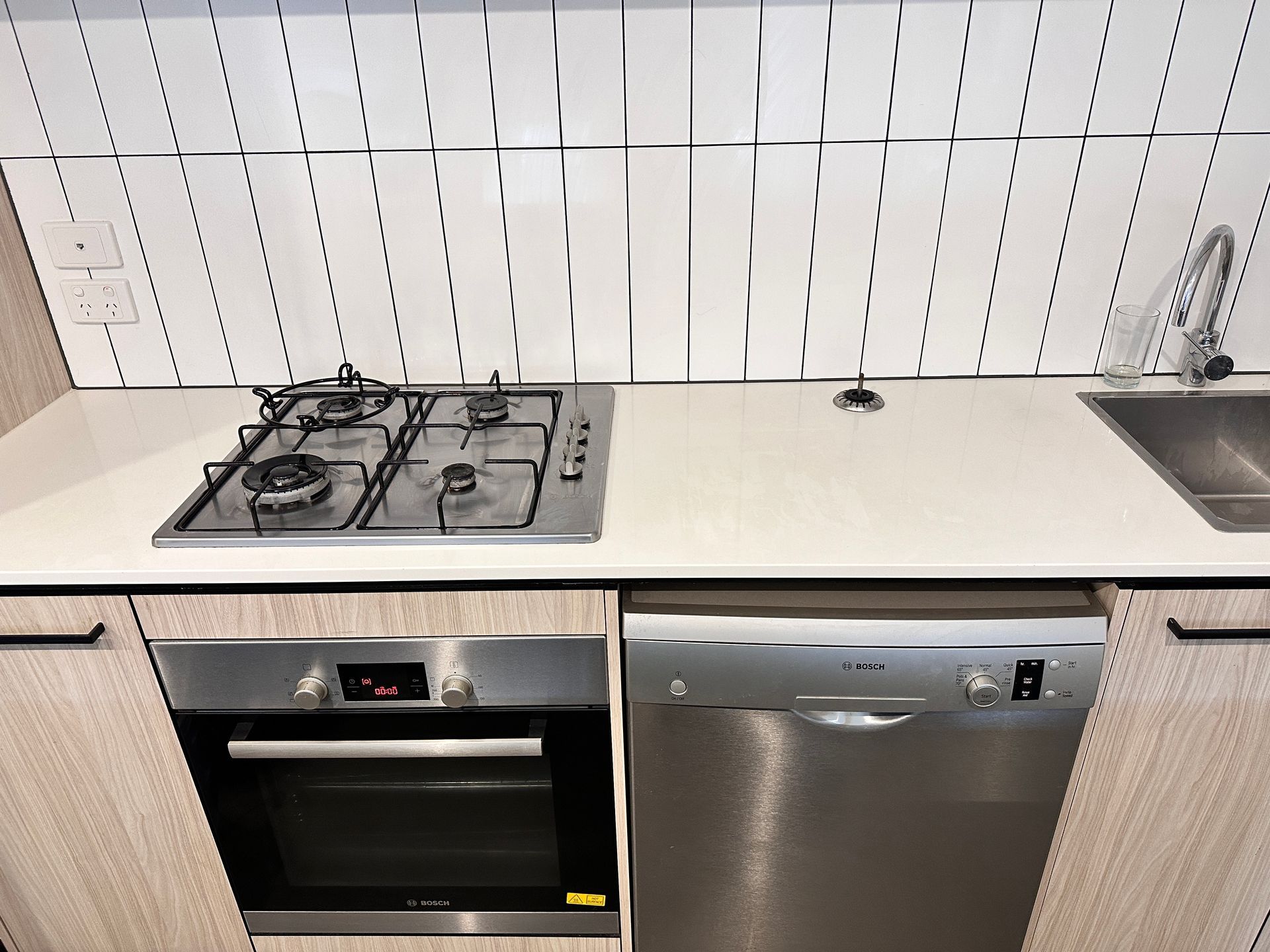 A kitchen with a stove top oven and a dishwasher