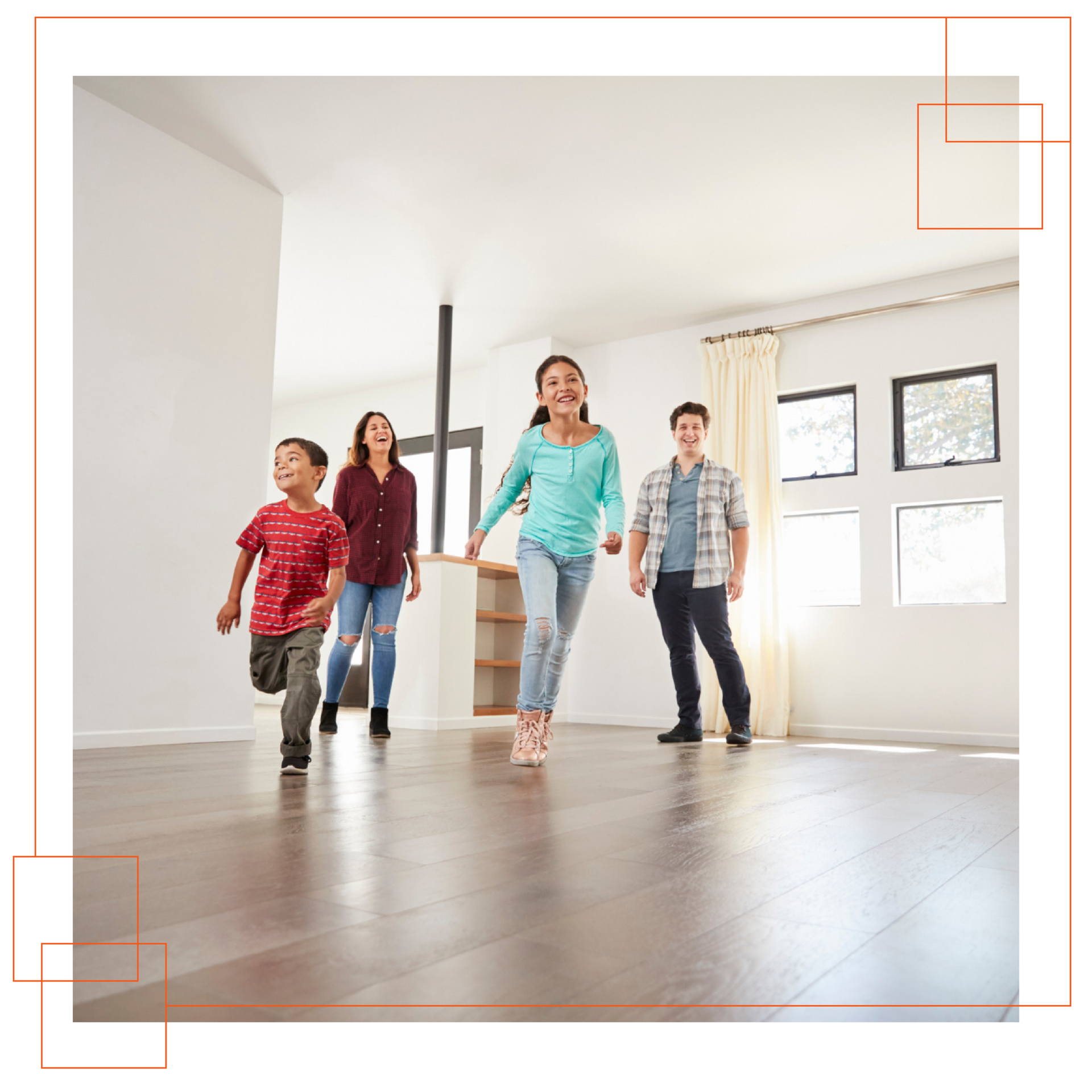 A family is walking through an empty room in a new home.