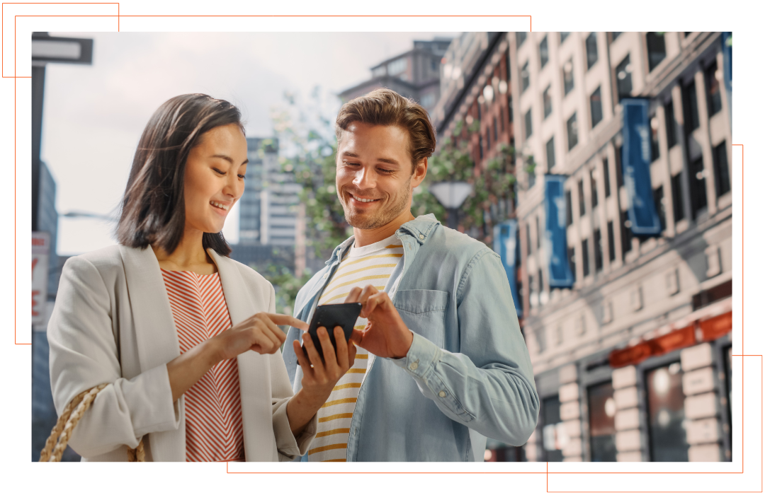 A man and a woman are looking at a cell phone.