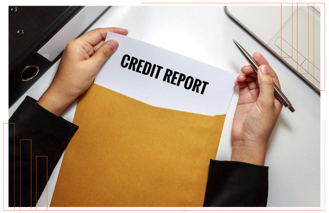 A person is writing on a piece of paper that says credit report