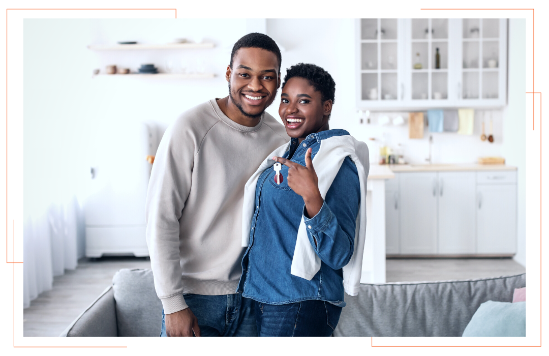 A man and a woman are standing next to each other in a living room.