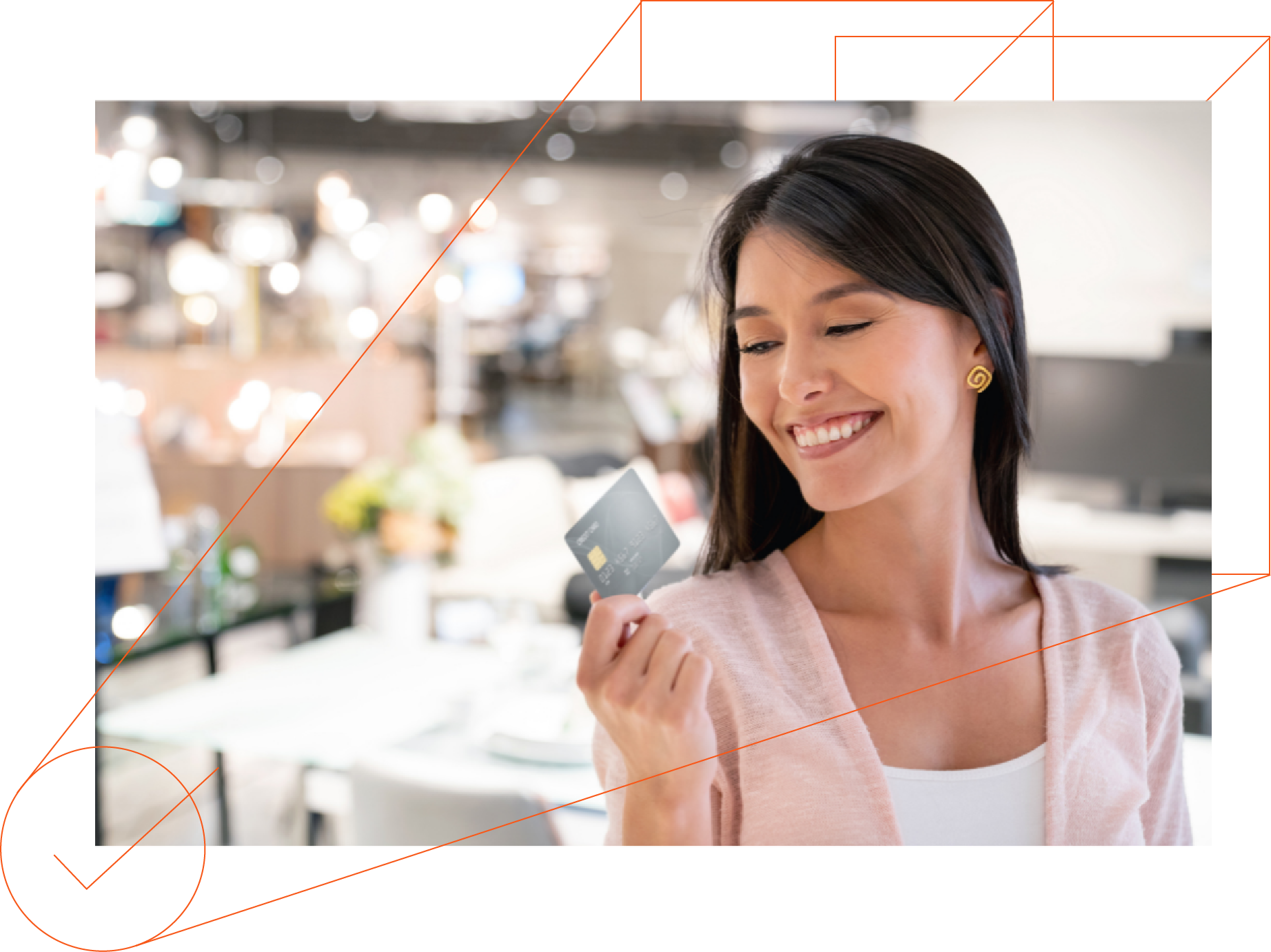 A woman is smiling while holding a credit card in a store.