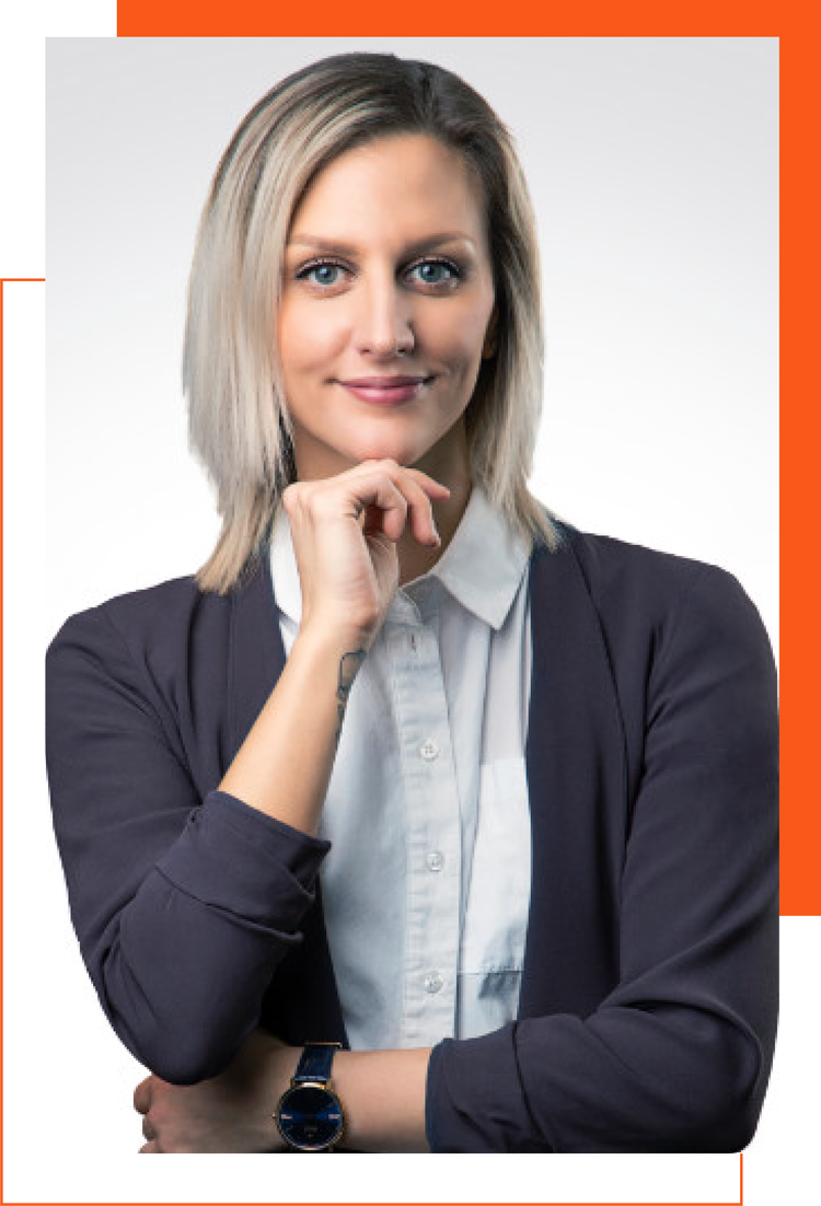 The woman is wearing a watch and a sweater and has her hand on her chin.