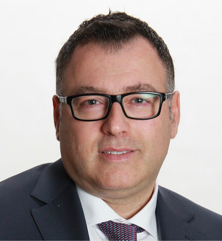 A man in a suit and tie is wearing glasses