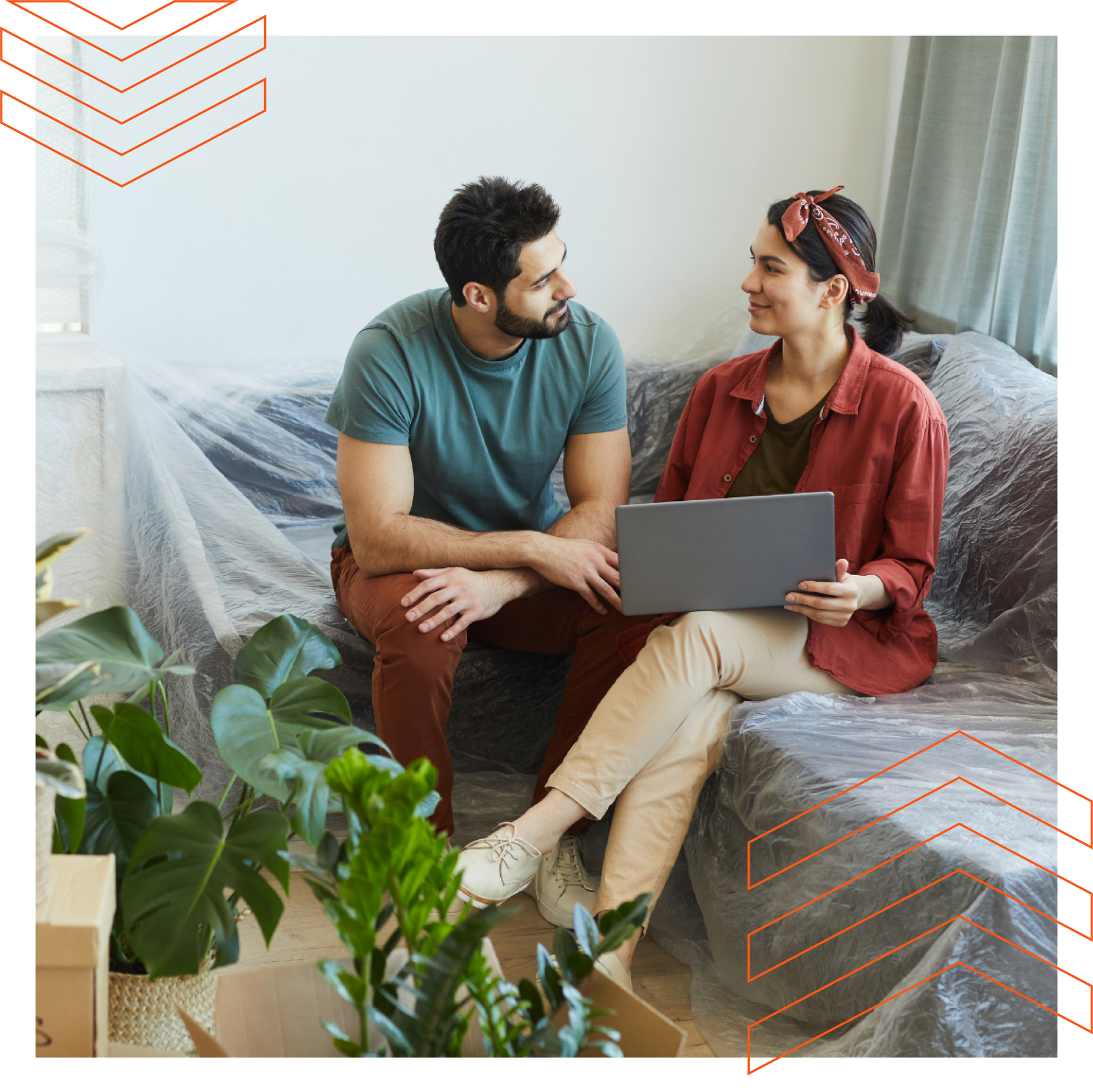 A man and a woman are sitting on a couch with a laptop.