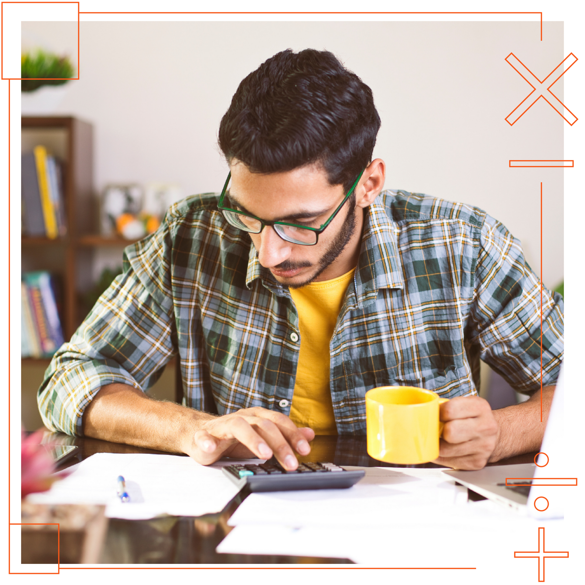 A man is sitting at a table using a calculator and a cup of coffee.