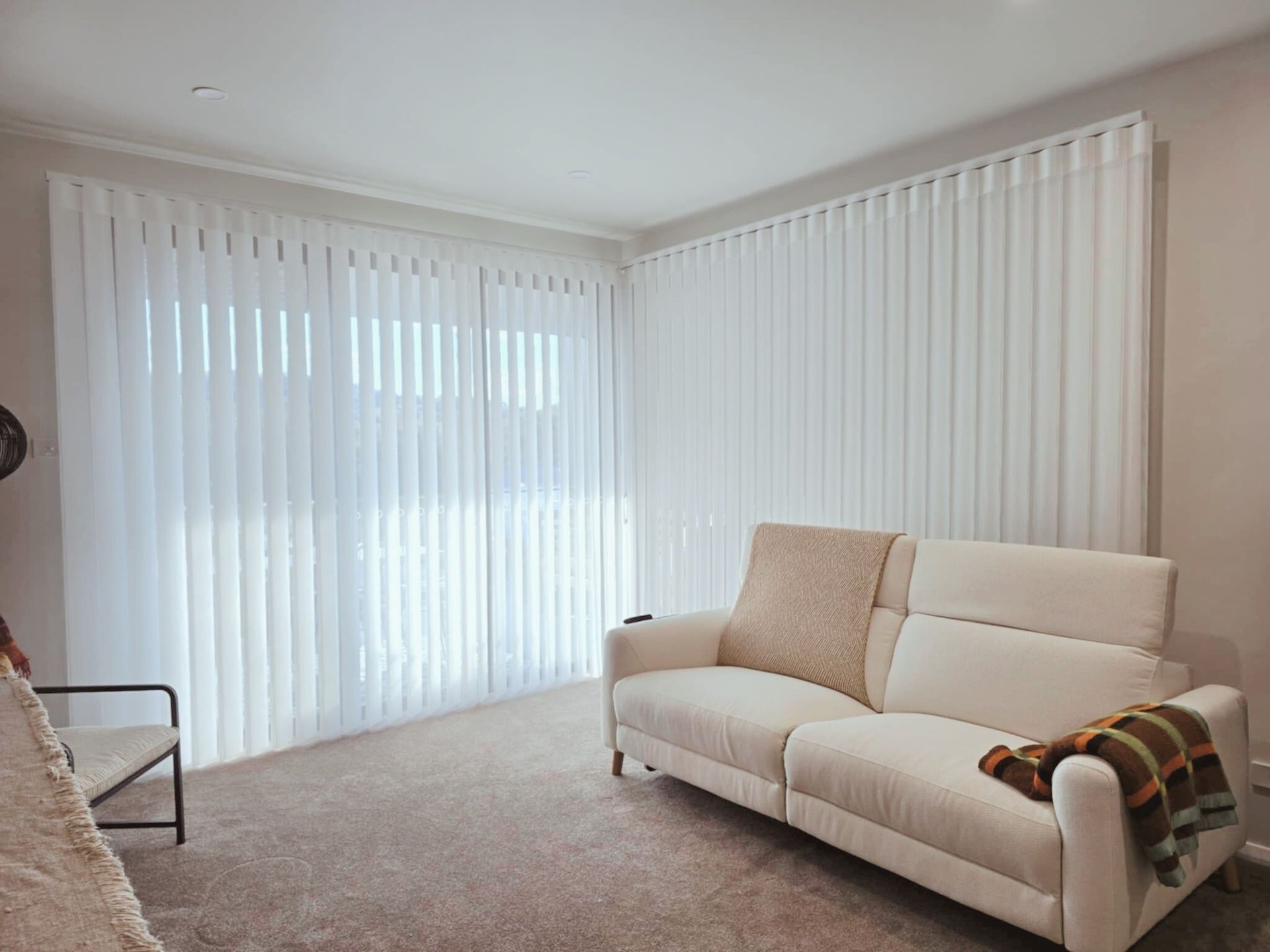 Beige curtains framing a bright window with sheer white curtains. Two teddy bears sit near the right side.