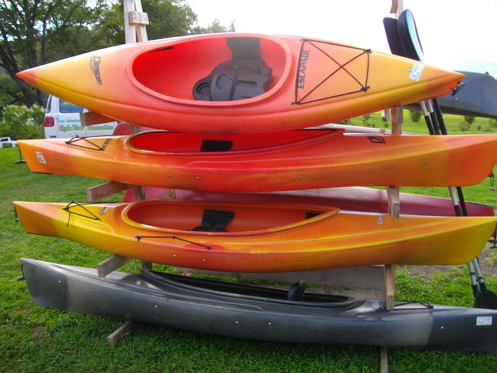 A bunch of kayaks are stacked on top of each other