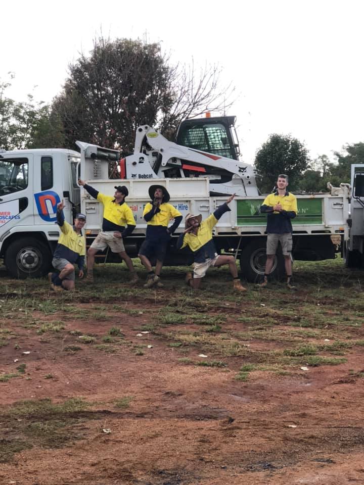 Team members of Dubbo Premier Landscape Company are posing in front of the branded truck in Dubbo, NSW