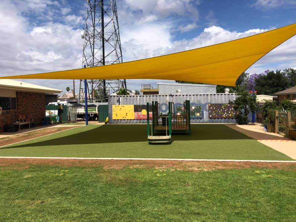 Synthetic grass installed on a playground in front of a commercial building in Dubbo