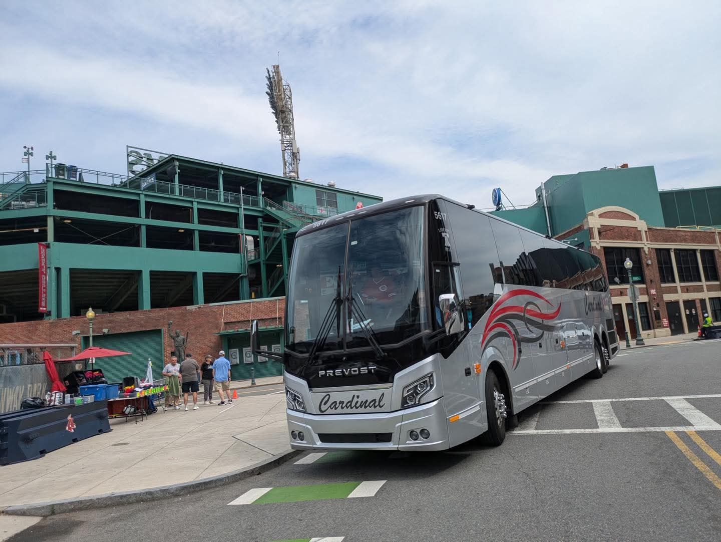 Bus driver pointing at wrist watch.