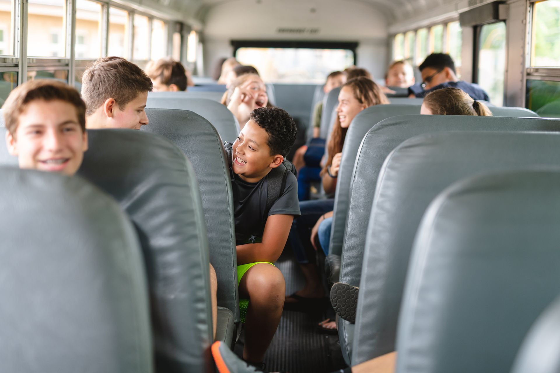 Students riding a school bus on a field trip, showcasing safe bus rental in Delaware, OH by Cardinal