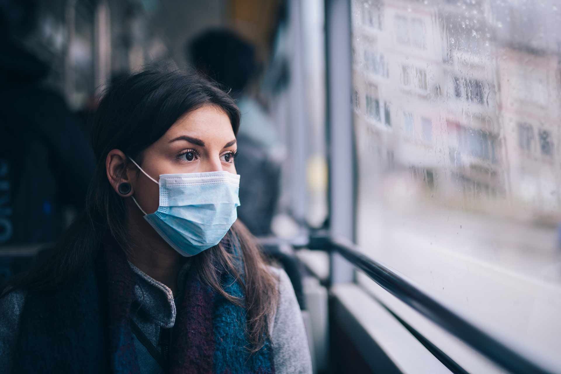 A woman with protective face mask enjoying a bus rental from Cardinal Transportation, LTD, in Delaware, OH