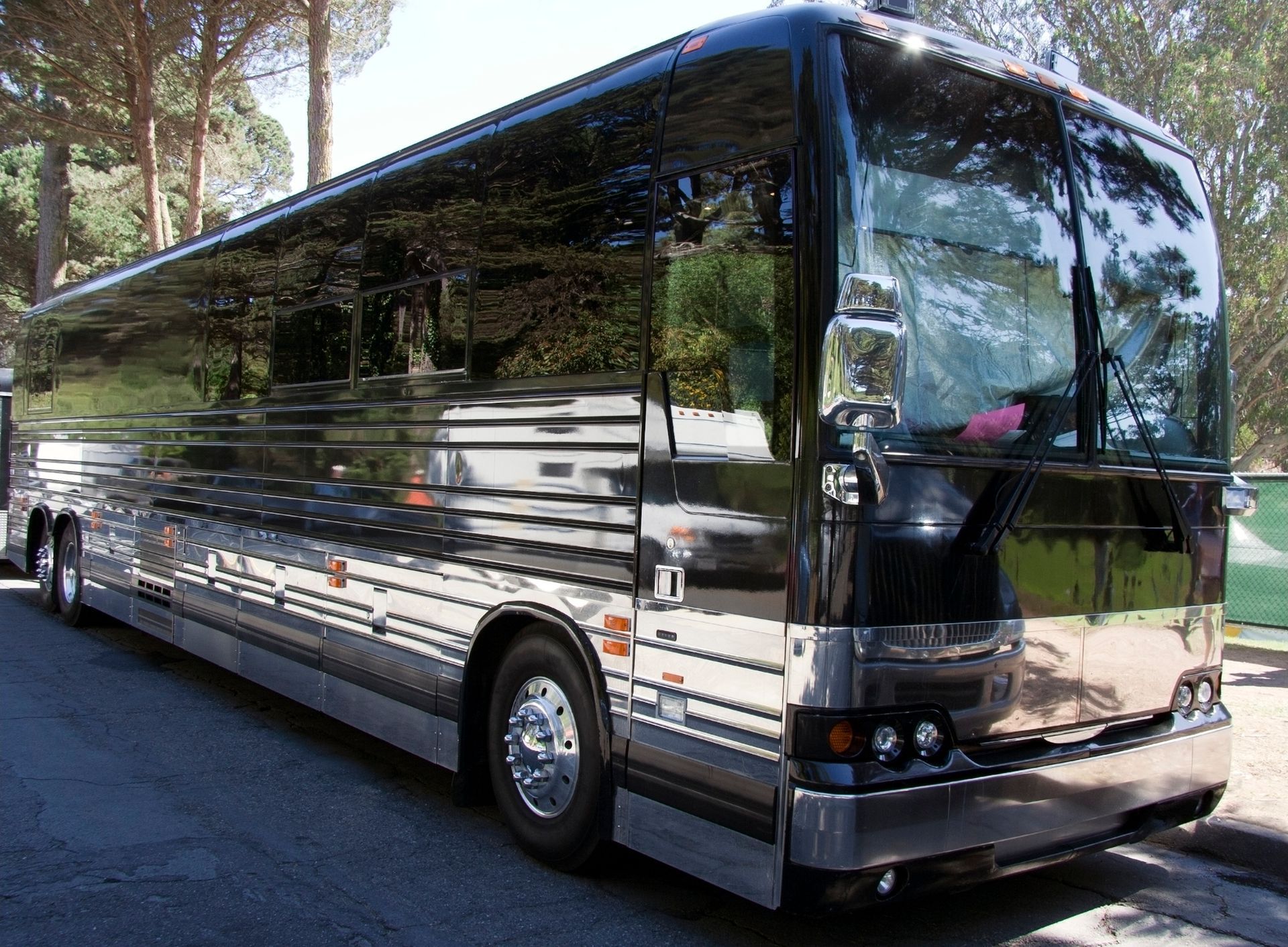 A black bus parked on the side of the road