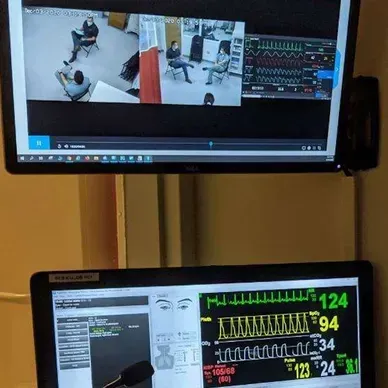 A person is holding a pineapple in a bag in a grocery store.