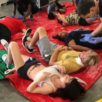 A person is holding a pineapple in a bag in a grocery store.
