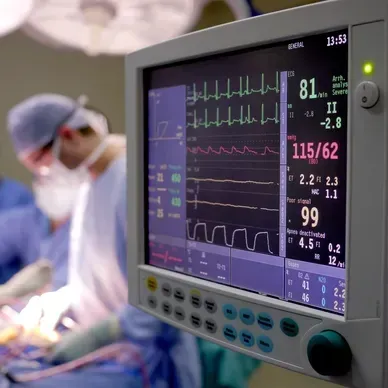 A person is holding a pineapple in a bag in a grocery store.