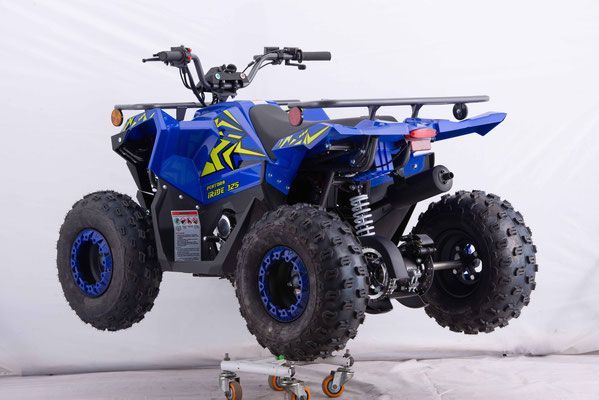 A blue atv is sitting on a cart on a white background.