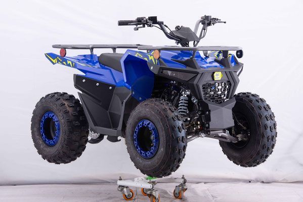 A blue atv is sitting on a cart on a white background.