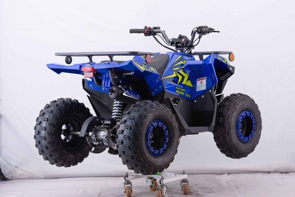 A blue atv is sitting on wheels on a white surface.