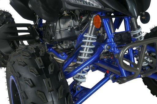 A close up of a blue atv with a large tire