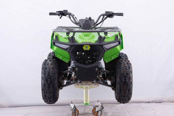 A green atv is sitting on top of a cart.