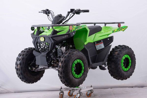 A green atv is sitting on top of a cart.