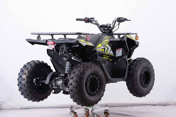 A black and yellow atv is sitting on a cart.