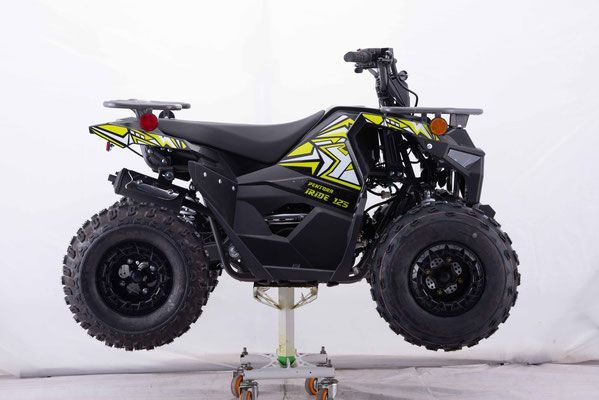 A black and yellow atv is sitting on a cart.