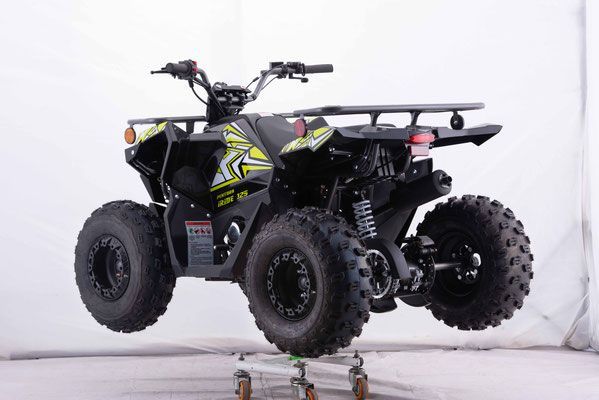 A black and yellow atv is sitting on top of a cart.