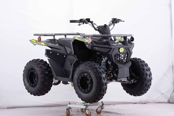 A black atv is sitting on a cart on a white background.