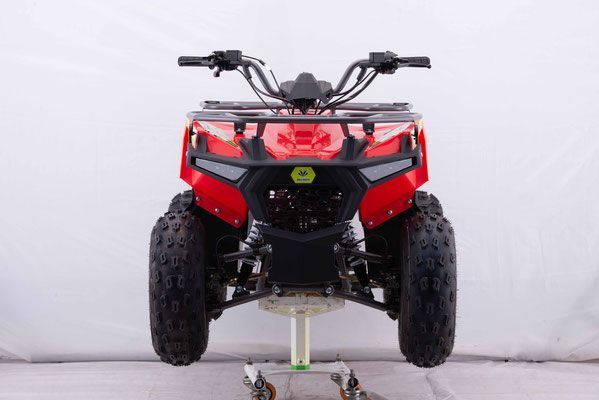 A red atv is sitting on top of a white table.